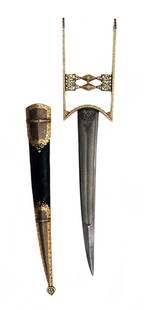 AN INDIAN DAGGER KATAR: An exceptional example of superb quality, the iron hilt of characteristic form with paneled, pierced and chiseled terminals and grips, heavily inlaid with gold in intricate patterns overall. The scabb