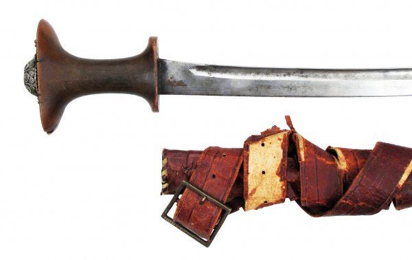 AN ETHIOPIAN SABER GURADE: An earlier example than usually found, the grip of a single large section of horn with filigreed silver boss to pommel. The exceptionally long, heavily-curved and fullered blade of excellent native wo