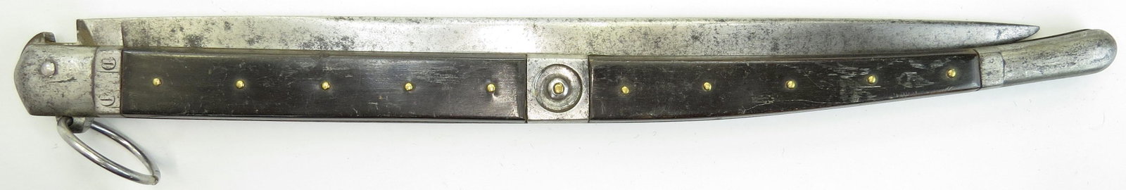 A RARE NAVAJA CLASP KNIFE: A large and well-made example, the steel mounts with panels of horn engraved with the owner?s initials GG on the bolsters, the single-edged blade retaining areas of original edge and struck with an il
