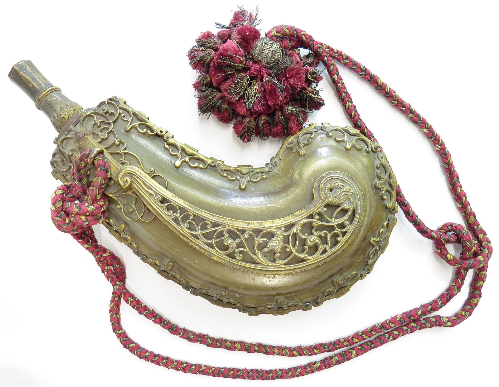 A FINE NORTHERN EUROPEAN POWDER FLASK: French or German court workshop work, the body of pressed golden horn with finely stepped borders in baroque form, with sprung cutoff and elegantly pierced mounts throughout, each heavily gilded, incl