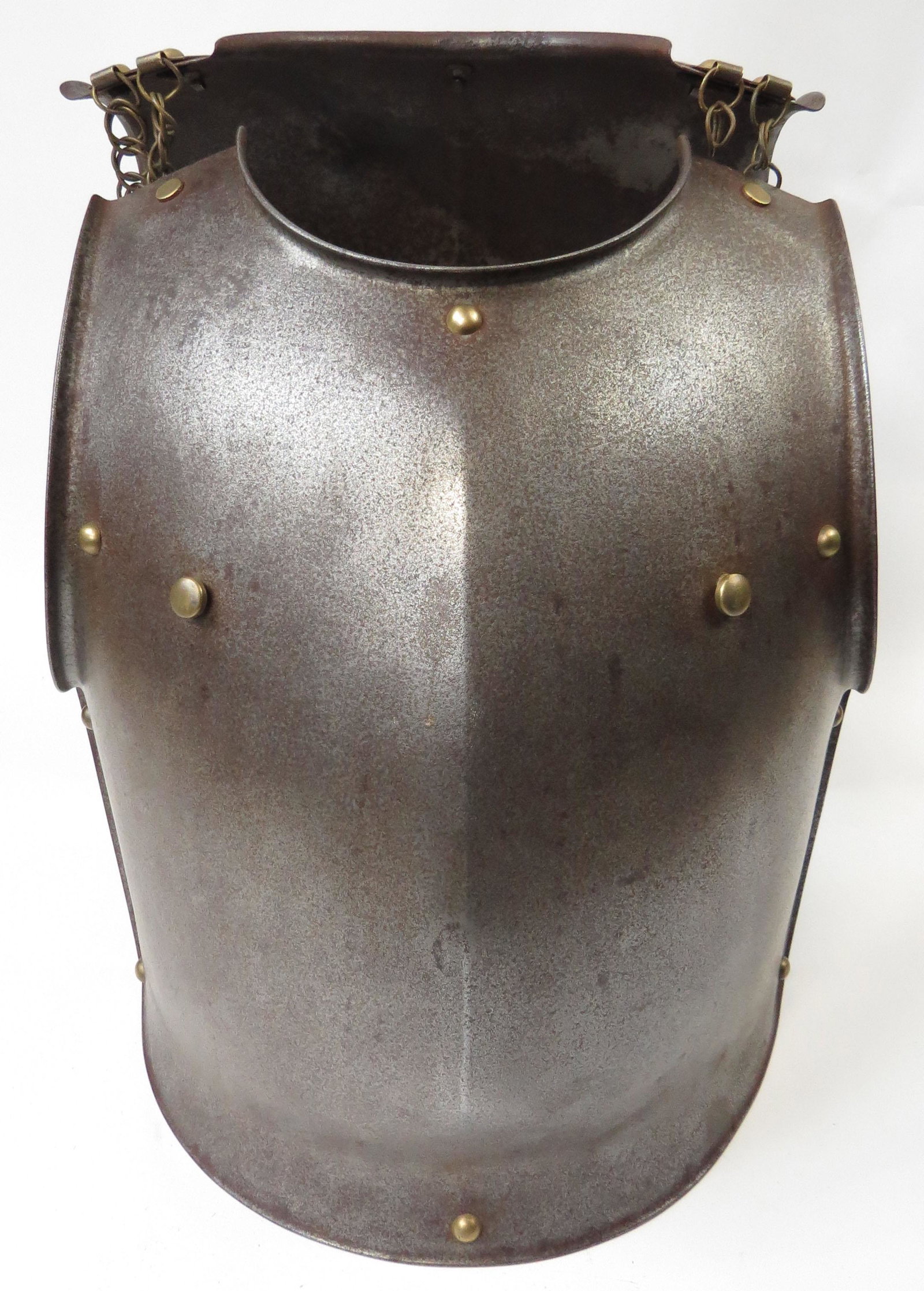 A FRENCH CUIRASSIERS BREAST AND BACKPLATE: Of steel, with raised neck and arm apertures, and bordered with brass studs, the breastplate is of considerable weight and thickness. The backplate with chains intact. Marked on the interior of the br