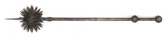 AN INDIAN GURZ MACE: Forged entirely of steel, the spherical head thickly set with quadrangular spikes and a long top-spike. The haft with faceted ferrule and bands of silver inlay decoration in vegetal motifs to the cent