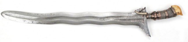 A FINE MORO DATU'S KRIS SWORD: A FINE MORO DATU’S KRIS SWORD Maguindanao work, the junggayan hilt typically carried by a datu or noble, with ivory kakatua-form pommel and silver mounts in two colors, alternating bands of okir eng