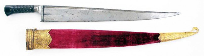 AN AFGHAN SALAWAR SHORTSWORD: An unusually elaborate example of the weapon also known as a Khyber knife, the blade of characteristic form with T-back, quite broad at the forte. The iron bolsters scalloped and faceted, the dark hor