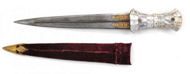 AN INDO-OTTOMAN HANCER DAGGER: The grip of characteristic Ottoman form, with flared terminals and beaded center, secured by two iron bosses with heavy gold inlay. Mughal influence evident in its mother of pearl mosaic surface, with