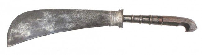 A RARE MOPLAH SWORD: A weapon endemic to the Moplahs, or Mapillas, a Muslim group of Malabar. The carved wooden grip hooked and faceted with semicircular fingerstall and long, profiled and beaded ferrule. The blade flared