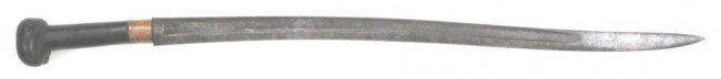 A BALKAN YATAGHAN-TYPE SWORD: Probably Croatian trench-made, the grip hand carved and applied to a recurved bayonet blade struck with a K and a maker's mark in the form of a knight's helmet. Comprehensively first quarter of the 20