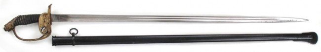 A PRUSSIAN MODEL 1889 INFANTRY OFFICER'S SWORD: The brass hilt with Prussian crest on the guard, the grip with original sharkskin and wire wrap. Straight, single-edged, double-fullered blade struck at the forte W.K & C and retains its bright finish