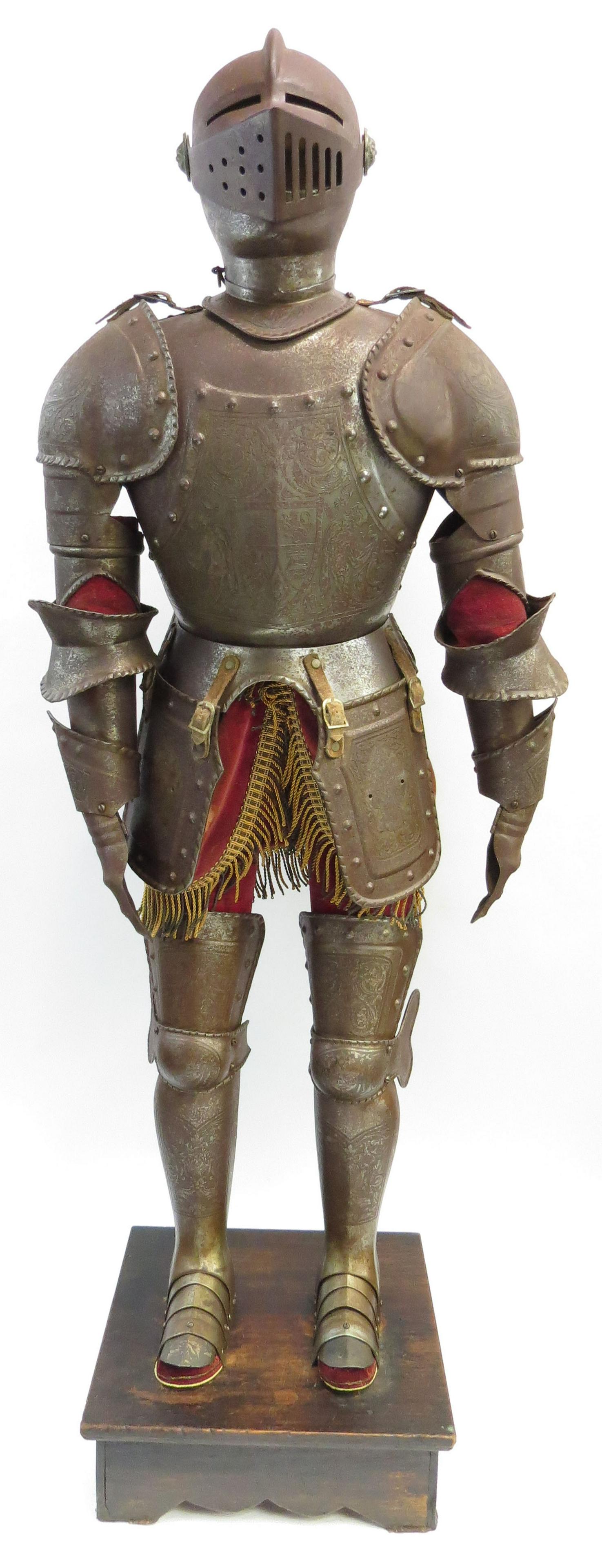 A MINIATURE SUIT OF ARMOR: In the Spanish style, handwrought, each well-detailed steel plate finely detailed and articulated, with elaborate etched decoration throughout and velvet accents. Functional visor. On its wooden stand