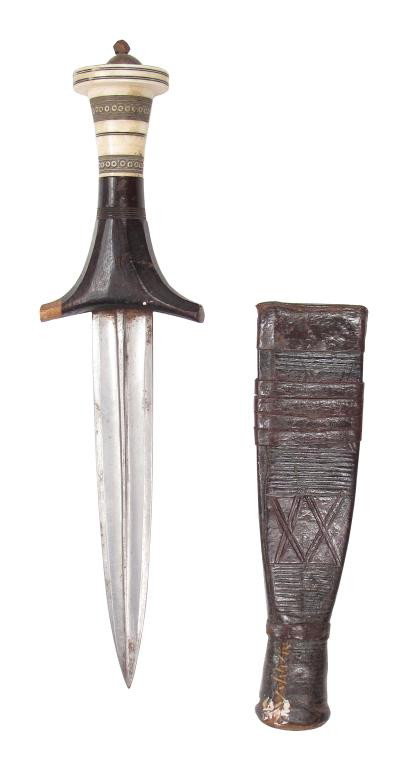 A SUDANESE DAGGER: The ebony and organic grip with elegant guard and disk pommel decorated with bands of birdseyes. The straight, double-edged blade well forged with raised central rib and chamfered edges. The paneled s