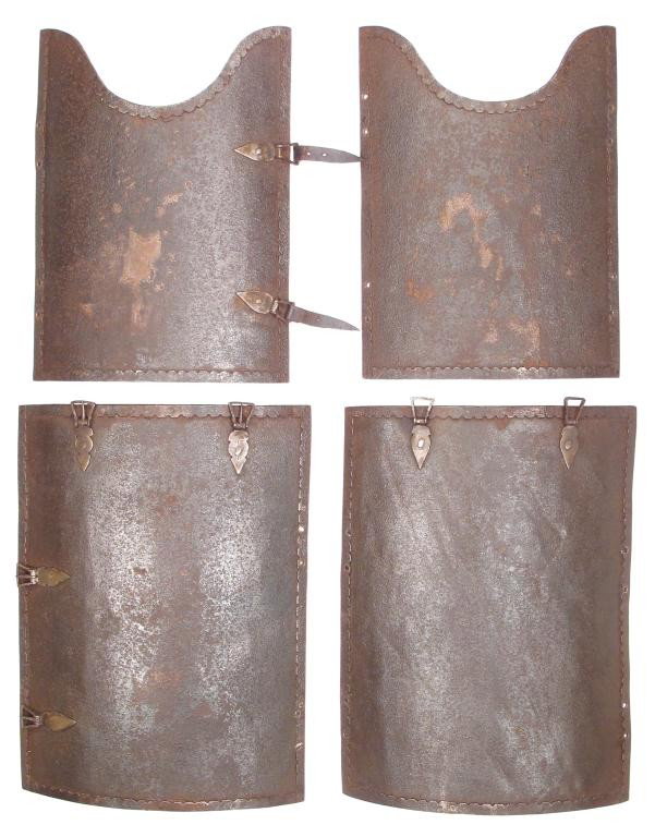 A SET OF MUGHAL TROOPER’S CHAR AINA ARMOR PLATES: Forged entirely of steel, each plate bordered with scalloped borders and bud-shaped buckles. Mid-18th century. Buckles replaced, several lacking. Height of the largest plate 31.2 cm. Condition III