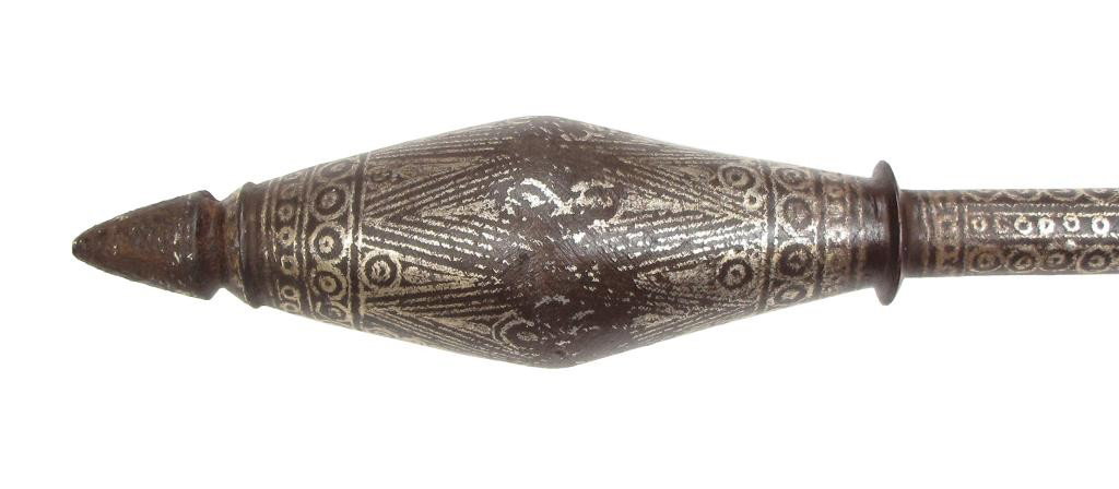 A RARE PERSIAN STEEL MACE: The elongated biconical head with spiked terminal and flanged base, the faceted haft with stepped finial.Heavily inlaid overall with silver in geometrical motifs. Beginning of the 17th century, Wear t