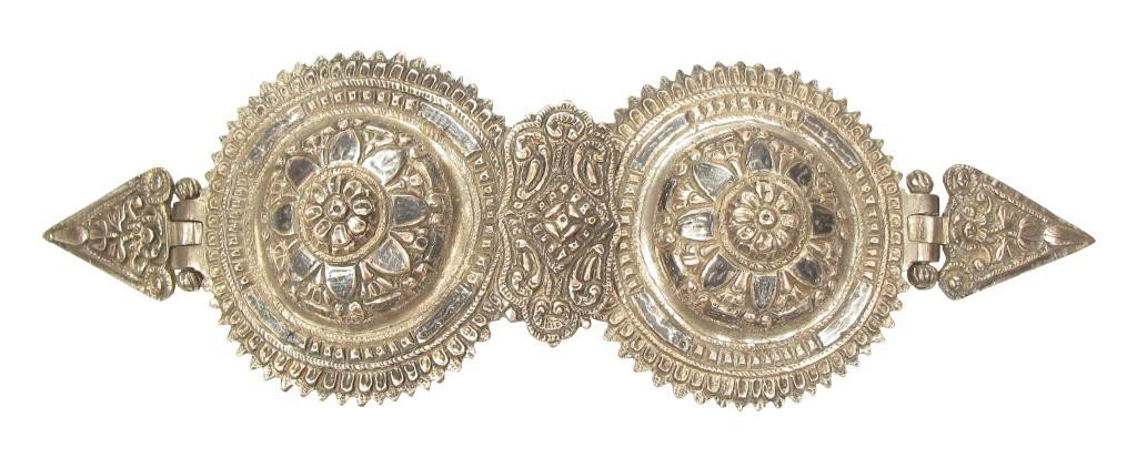 A GREEK SILVER BELT BUCKLE: Of classic form, wrought entirely of silver with rococo plaque to center, deeply engraved and nielloed overall.Dating to the War of Greek Independence.First quarter of the 19th century.Overall length 