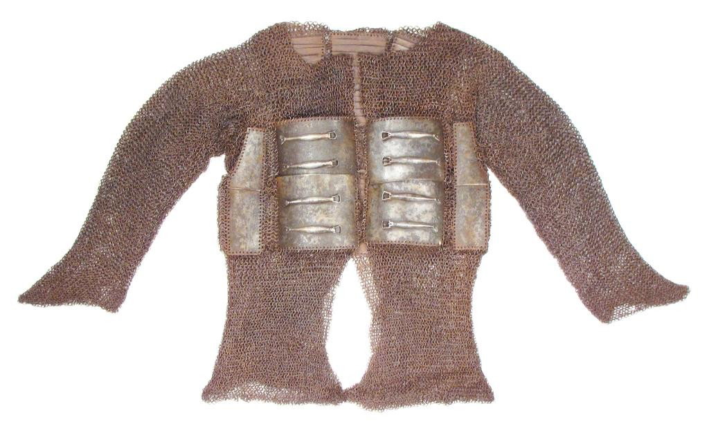 A MUGHAL TROOPER’S PLATE AND MAIL ARMOR: Of high quality, likely an officer’s coat.Forged of heavy, riveted rings set with forged steel plates in the characteristic pattern; those at the back and sides with scalloped borders, the closures 