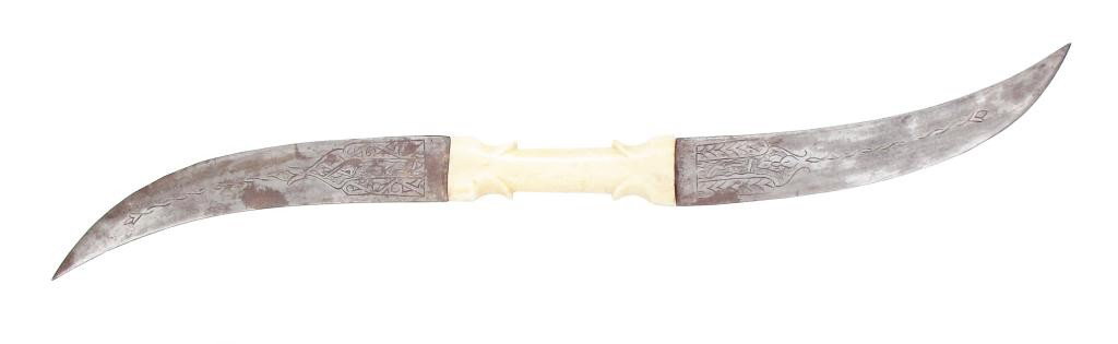 A SUDANESE DOUBLE-BLADED HALADIE DAGGER: The symmetrical bone grip with flared and stepped bolsters, the curved, double-edged blades engraved at each forte. A type commonly used by the Samaniyya Sufis under Mahdi Muhammad Ahmad. Last quarter