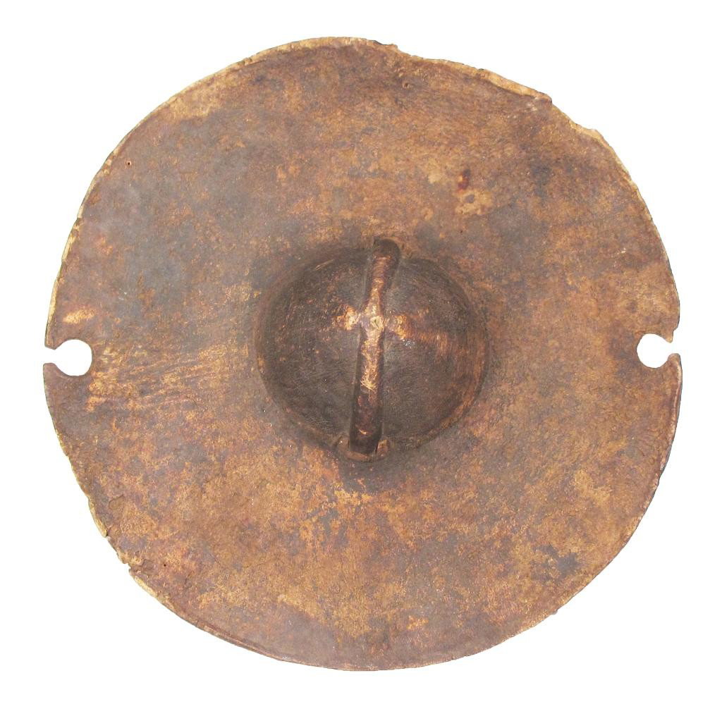 A RARE SUDANESE SHIELD: A form carried by the Beja of Northern Sudan, composed of thick hide with a semicircular notch at either side. Surmounted by a molded boss with original grip intact.Second half of the 19th century.Min