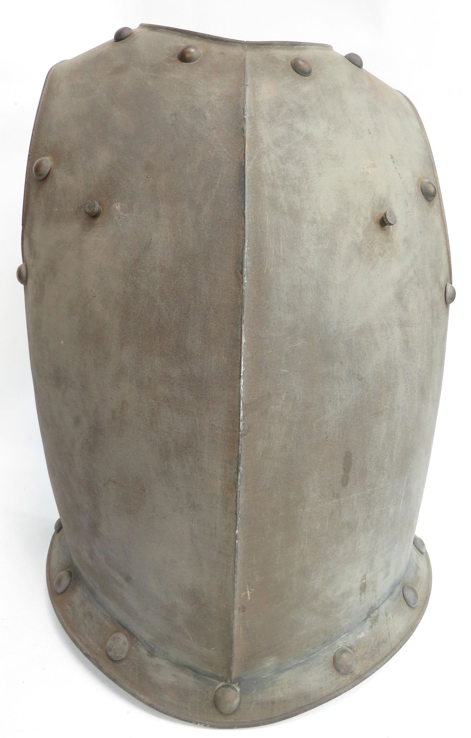 A CUIRASSIER BREASTPLATE: Wrought of steel in characteristic form with central ridge, flanged at the lower edge and set with bosses around the periphery. Retains its studs for shoulder straps. Relatively light, likely made for