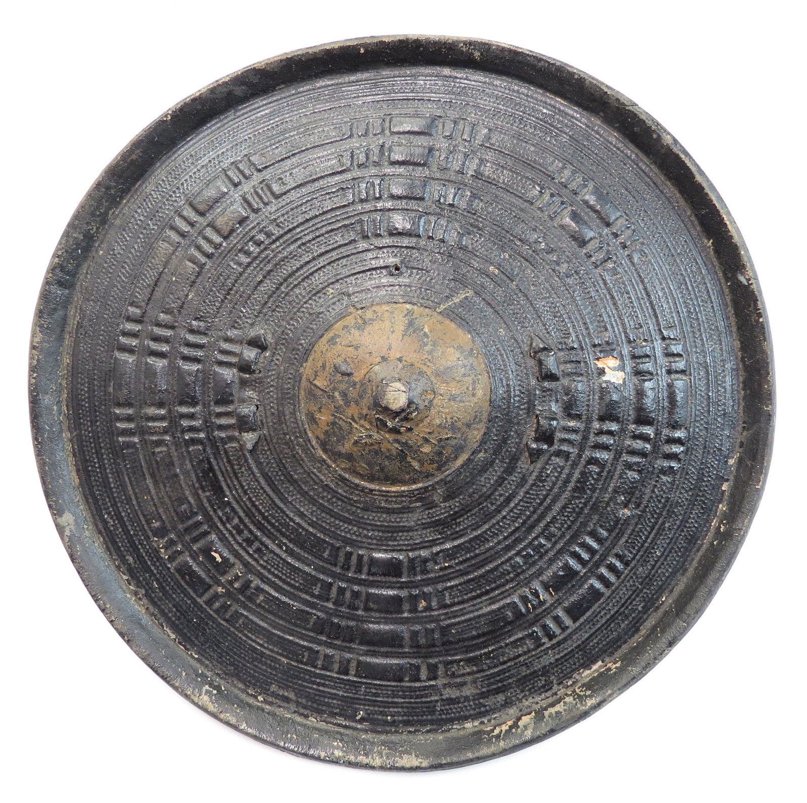 A RARE ABYSSINIAN HIDE SHIELD: Of molded rawhide with separately-applied grip, the obverse with characteristic minute geometrical tooled motifs overall. Mid-19th c. Diameter 35cm. Condition II