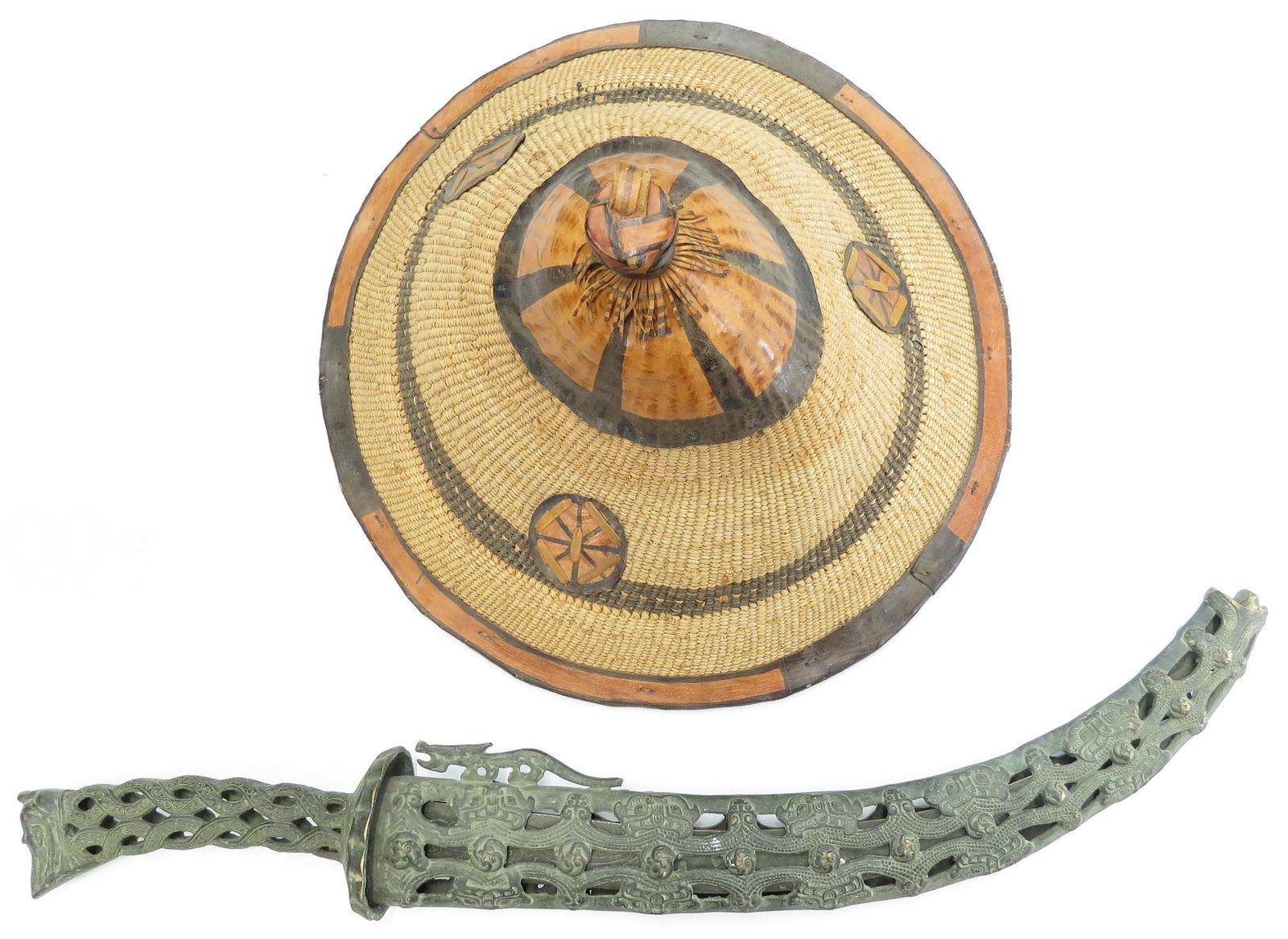 AN AFRICAN CAP AND BRONZE SWORD: A woven Fulani cap of characteristic form with leather appliques and a bronze sword with ergonomic hilt and curved blade, in its pierced sheath. 20th c. As found. Overall height of cap 38.5cm, sword l