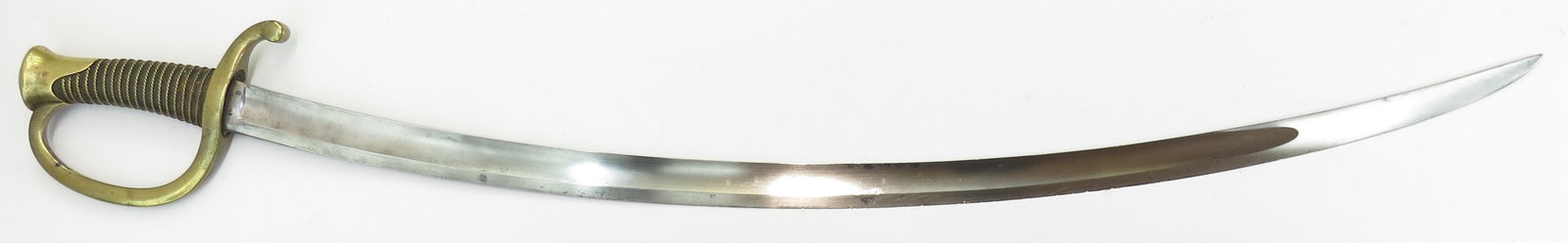 A FRENCH M 1822 ARTILLERY SABER: Of characteristic form, with brass guard and leather-covered grip which retains its twisted wire wrap. The curved, fullered blade struck with control marks at the forte and marked at the spine Manufac