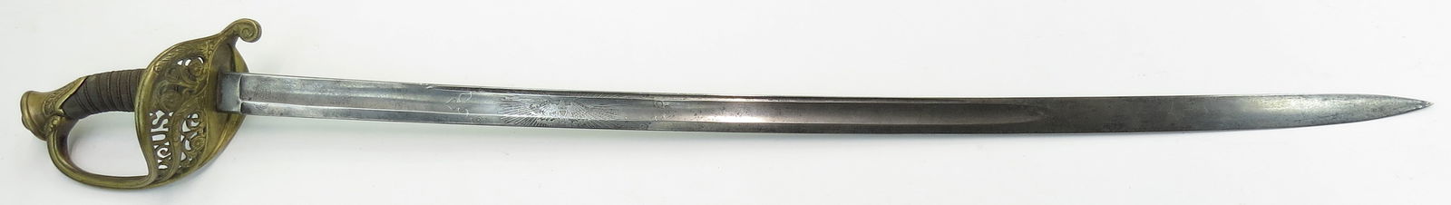 A U.S. M 1850 MOUNTED OFFICERS STAFF & FIELD SWORD: The elaborately embellished brass pommel and guard with pierced U.S. among flowering vinework, the grip with sharkskin covering and twisted wire wrap intact. The curved, fullered blade marked TIFFANY