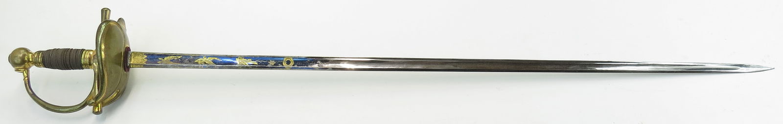 A PRUSSIAN M 1818 OFFICERS SWORD: The gilded hilt with boat-type guard with raised rim and partly raveled silver wire wrap. The fine, straight, single-edged blade with broad fuller deep fuller, blued and gilt for approximately half it