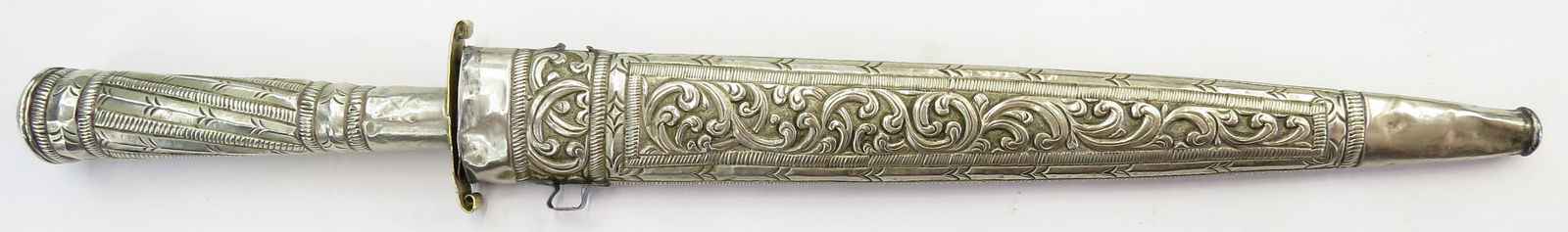A RARE ALGERIAN FLYSSA DAGGER: Seldom encountered, the silver or silvered mounts showing considerable Spanish influence combined with Ottoman rococo decorative motifs. The straight, double-edged blade with engraving and brass inlay