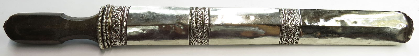 A TIBETAN DAGGER: Of characteristic form, with horn grip and elegant engraved mounts, the blade grooved and single-edged. 19th-20th century. Minor wear, tip dented. Overall length 42cm/ 16.53". Condition II