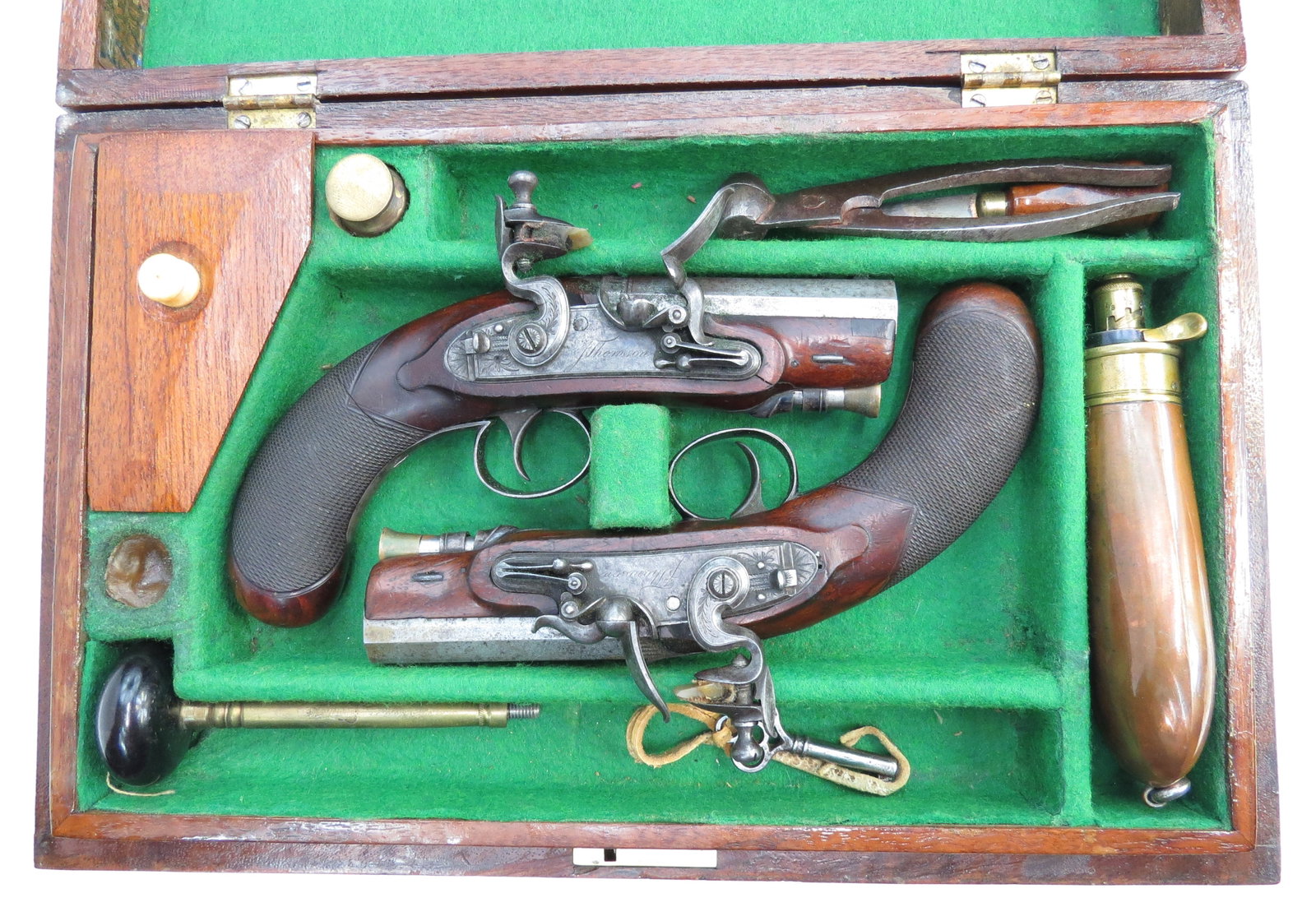 A RARE PAIR OF SCOTTISH CASED FLINTLOCK PISTOLS: With walnut full stocks, the bag-shaped grips chequered, the fine locks with sliding safeties and platinum touch holes signed, J. THOMSON. The short octagonal barrels with silver fore sights and shall