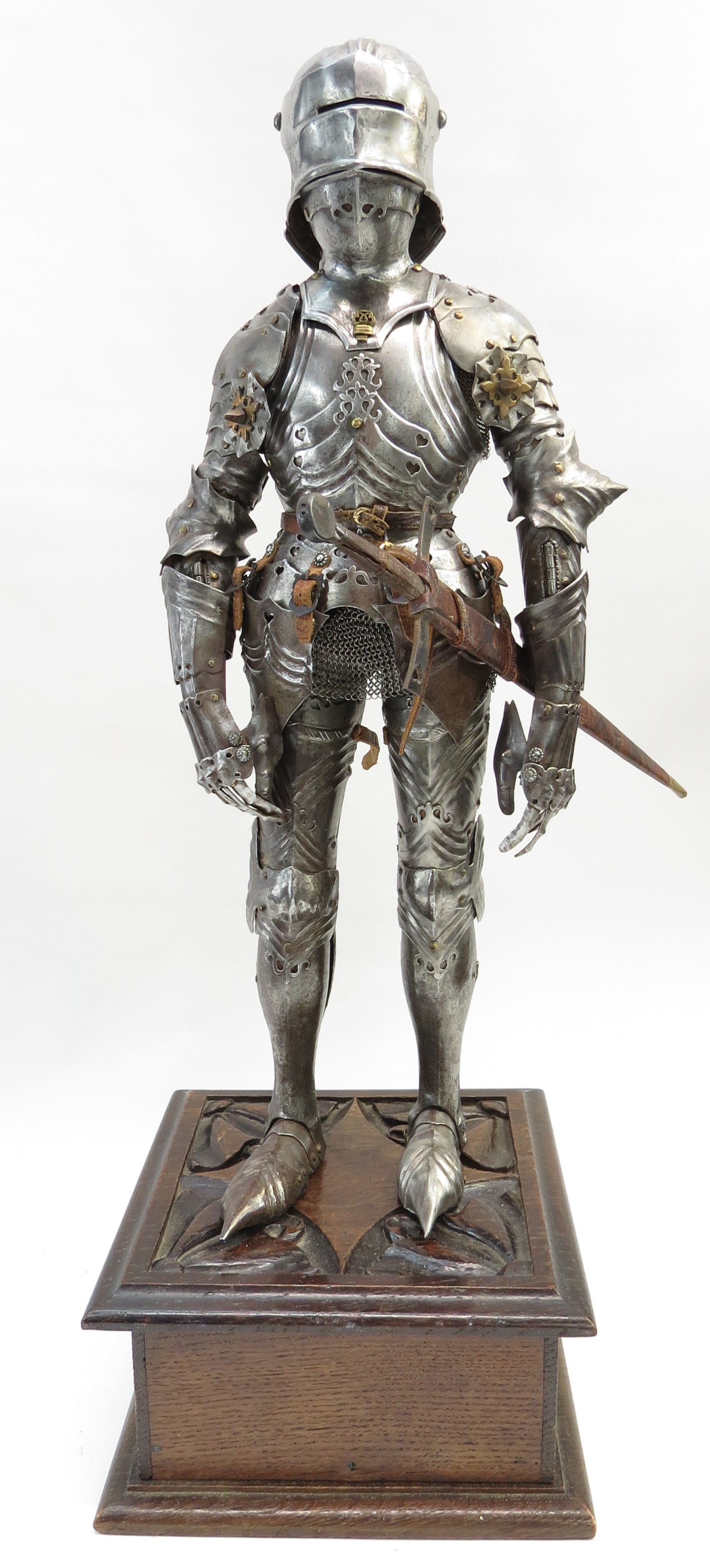 A FINE MINIATURE GOTHIC ARMOR SUIT: The work of a master armorer, a full suit handwrought entirely of steel, very finely detailed and fully articulated, the visored sallet helmet with articulated neck, two-part gorget with locking key,