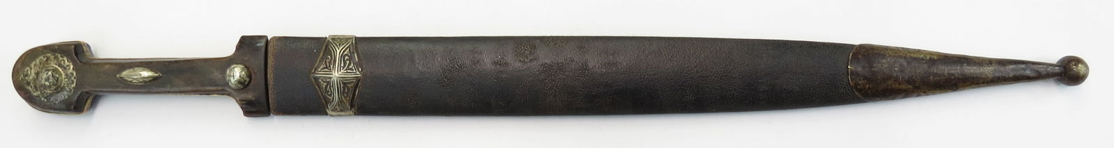 A CAUCASIAN KINDJAL DAMASCUS DAGGER: Of characteristic form, the horn grip with nielloed silver mounts, the massive double-edged bladewith central ridge, and inlaid gold makers mark at the forte. Wrought of fine, twistcore damascus steel