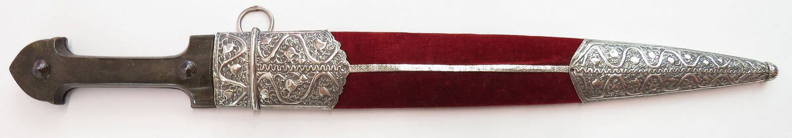 A LARGE CAUCASIAN BAZALAI KINDJAL DAGGER: A massive example with polished horn grips and steel bosses, the straight, double-edged blade with central ridge to each side, and a shallow panel at the forte with finely-engraved vinework, signed in