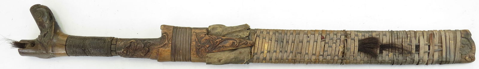 A BORNEO HEADHUNTER SWORD: Dayak People, the antler grip with intricately carved pommel. The hardwood scabbard with rattan wrap. The blade retaining a sharp edge. 20th century. Worn. Overall length 63 cm / 24 3/4". Condition II