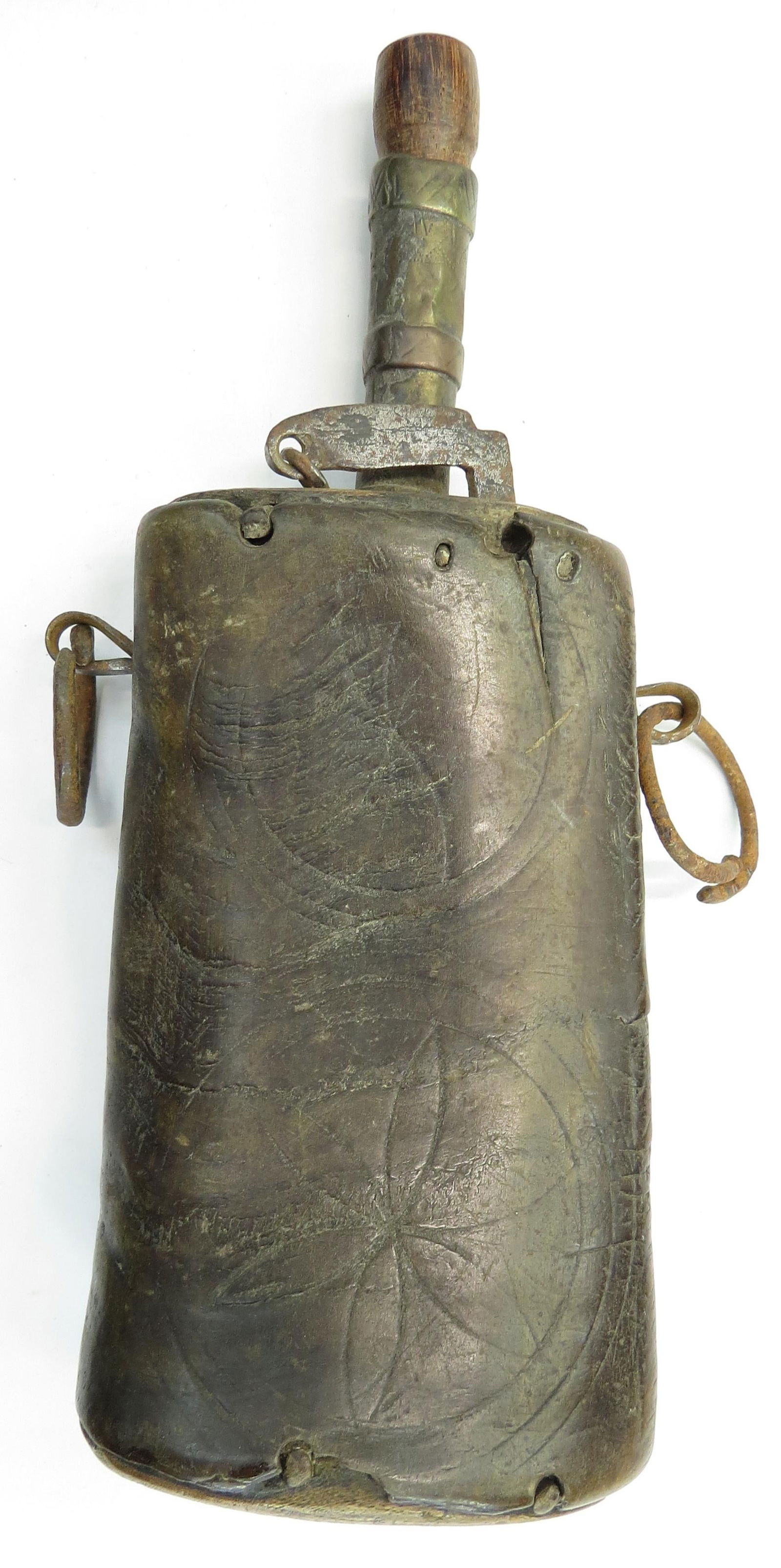 A RARE NORTH AFRICAN POWDER FLASK: Based upon 16th century European forms, the horn body of rectangular form, incised with geometrical designs. The brass spout with iron cutoff and suspension rings. 18th-19th century. Well worn, minor