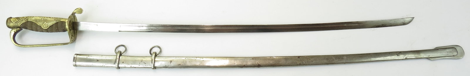 CHINESE NATIONALIST WW II SWORD: Brass hilt with Nationalist Chinese flags, rayskin-covered grip with brass wire wrap intact and single-edged blade. In its steel scabbard. Mid- 20th century. Worn, areas of rust. Overall length 95cm /