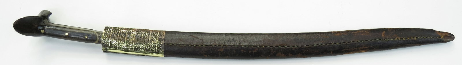 AN OTTOMAN YATAGHAN SWORD: The dark horn grips with large ears, the integral reinforces with silver inlay. The well-wrought blade of four rows of twistcore damascus steel with shallow back fuller and inlaid decoration to the le