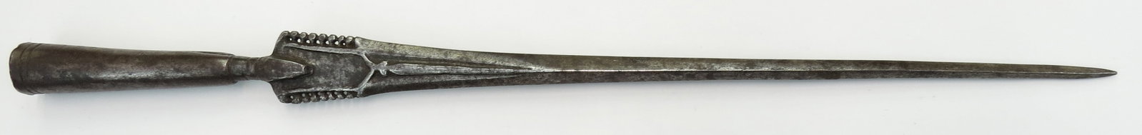 A RARE INDIAN SPEARHEAD: Earlier than typically encountered Mughal work of fine form, a massive example wrought with a heavy quadrangular armor-piercing head, fullered and intricately pierced at the base and showing an appare