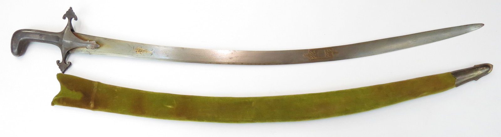A MASSIVE INDIAN SHAMSHIR SWORD: Mughal work, a true combat weapon. The fine persiform hilt of steel, with trefoil quillon terminals. The massive single-edged blade with chamfered cutting edge wrought of high contrast wootz and inlai