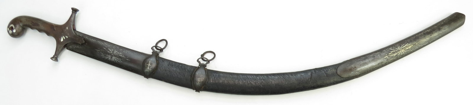 A RARE SYRIAN SHAMSHIR SWORD: A classic form produced in Ottoman Damascus, the steel hilt possibly wootz, with rolled pommel and guard with expanded quillon terminals inlaid with silver. The fine Persian heirloom blade dating cent