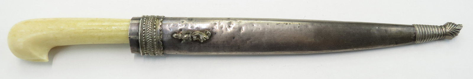 AN OTTOMAN BICHAK DAGGER: Istanbul work. Grip carved from a large section of figured walrus, the bolster engraved and heavily gilded, the blade of characteristic form, single-edged and wrought of dramatically-patterned Persian