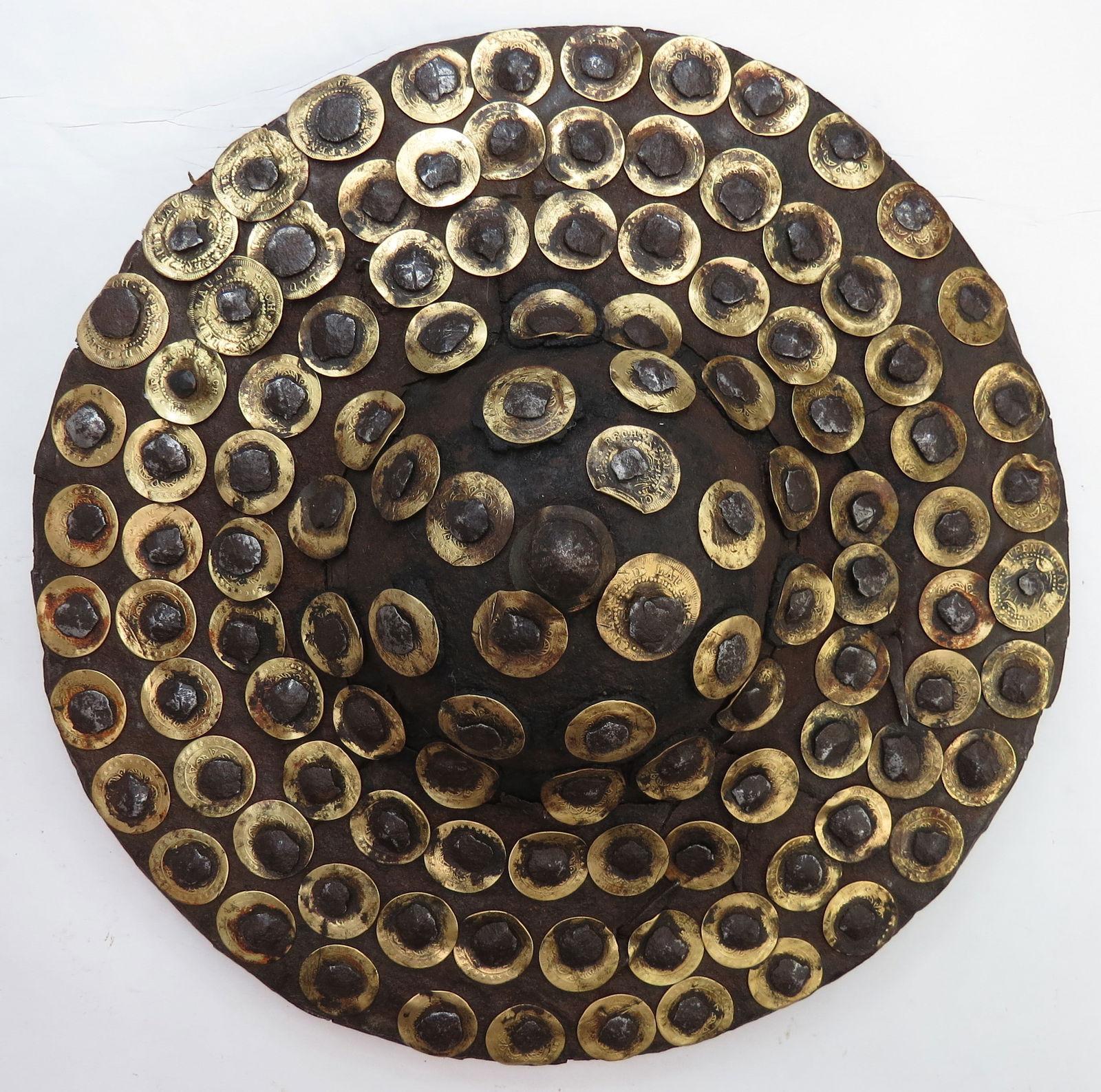 AN OTTOMAN KALKAN BUCKLER SHIELD: A rare example of characteristic form, the body formed of cane in a tightly-wound spiral, lightly domed in profile, with each ring wrapped in woolen cord. With applied studded steel boss, the whole co