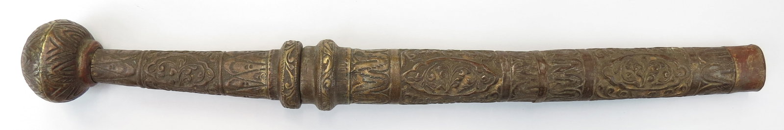 A BURMESE DHA DAGGER: The embossed brass grip with spherical pommel, the blade well-wrought with silver inlaid panel. The scabbard en suite. 20th century. Well worn. Overall length 44.6cm / 17 1/2?. Condition III