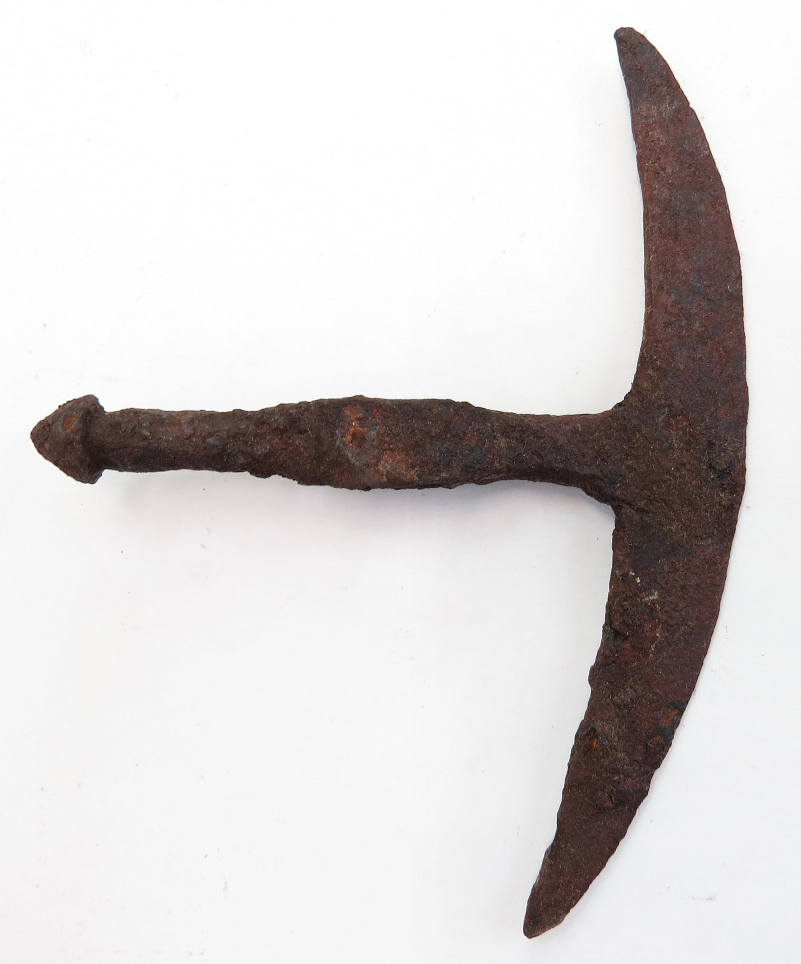 A RARE SCYTHIAN BATTLEAXE HEAD: Of characteristic form, finely wrought with large, crescent bit, with slender body and mushroom peen. 4th-2nd century BCE. Excavated. Overall length 15cm/ 6?. Such axes are often depicted in Hellenic