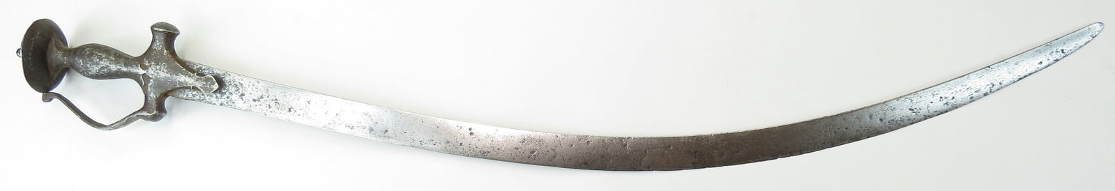 AN INDIAN TULWAR SWORD: An older example, the steel hilt with knucklebow, with long, curved, elegant single-edged blade. 17th century. Corroded. Overall length 88cm/ 34 5/8?. As found.