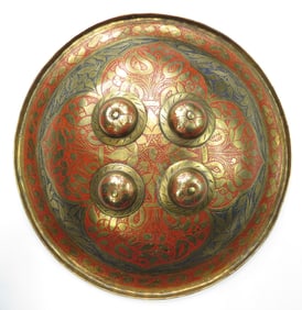 AN INDIAN ENAMELED BRASS BUCKLER SHIELD