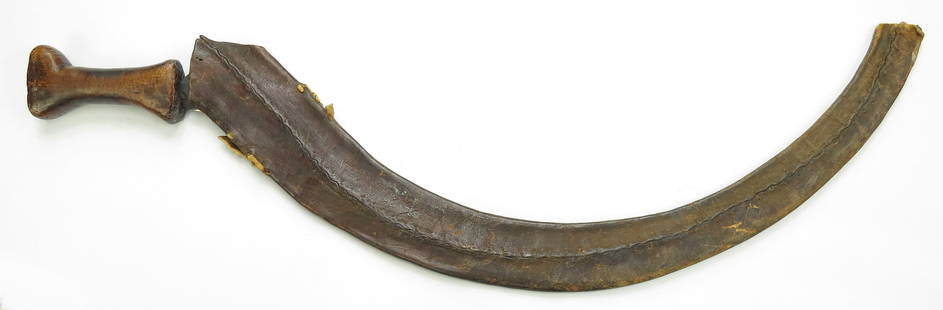 AN ETHIOPIAN SHOTEL SWORD: The heavily curved handwrought blade with pronounced central ridge, with wooden grip. In its hide scabbard. 19th century. Overall length 78cm./ 30 ? inches. Worn, losses. Condition IV