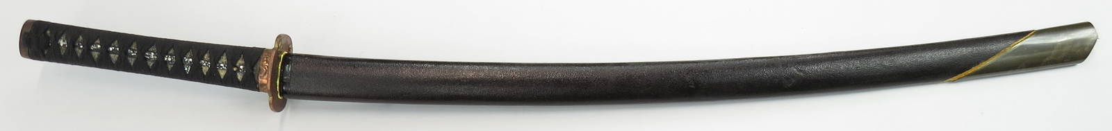 A JAPANESE KATANA SWORD: The copper tsuba set with well-modeled and gilded wisemen, copper fuchi and kashira. Tuka with replaced black ito. A finely wrought,elegant blade in very good polish with with active gunome temperline