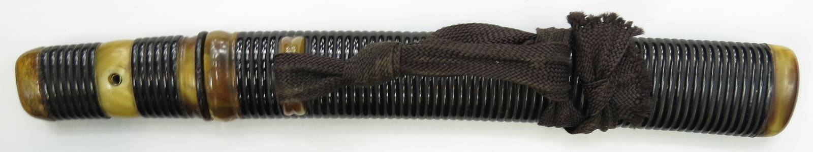 A JAPANESE TANTO DAGGER: The ribbed and black-lacquered mounts with blond horn fittings and silver two-part menuki and habaki. The rare blade of moroha zukuri type with some polish intact, mumei with two mekugi ana, with shor