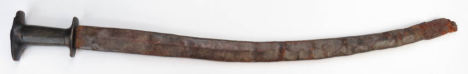 AN ETHIOPIAN GURADE SWORD: The horn grip of typical form, with silver pommel. Mounted with a lightly-curved and fullered blade. In its hide scabbard. Early 20th century. Worn overall, losses to scabbard. Overall length 90.5cm./