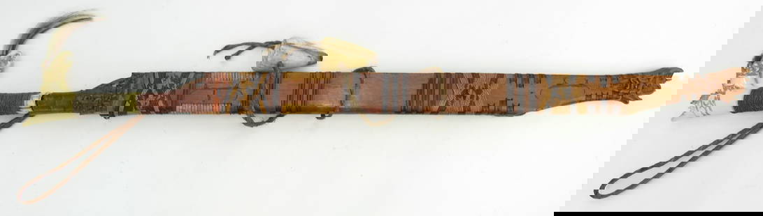 A FINE DAYAK HEADHUNTER PARANG IHLANG MANDAU SWORD: An above average example, the grip of antler, finely-carved with aso motifs and retaining its intricately-woven brass wrap and hair tassels. The handforged blade faceted at the right spine with expand